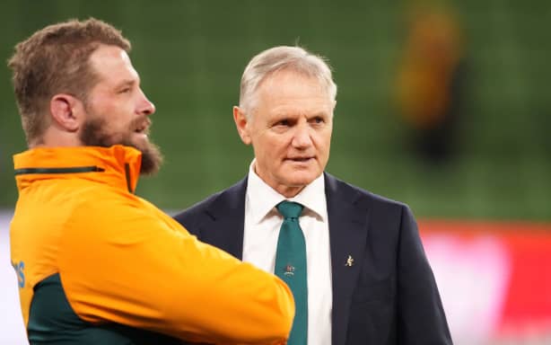 Joe Schmidt, head coach of the Wallabies, talks to prop James Slipper, 2024.