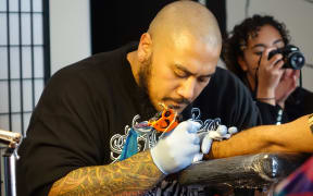 Tattoo artist Chris Amosa