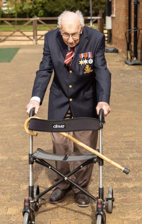 Alt text:
WWII veteran Captain Tom Moore, 99, walking in his garden in Marston Moretaine, Bedfordshire, to raise money for Britain's National Health Service (NHS).