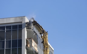 A large crane begins the demolition of the office block at 61 Molesworth St damaged in the Kaikōura earthquake.