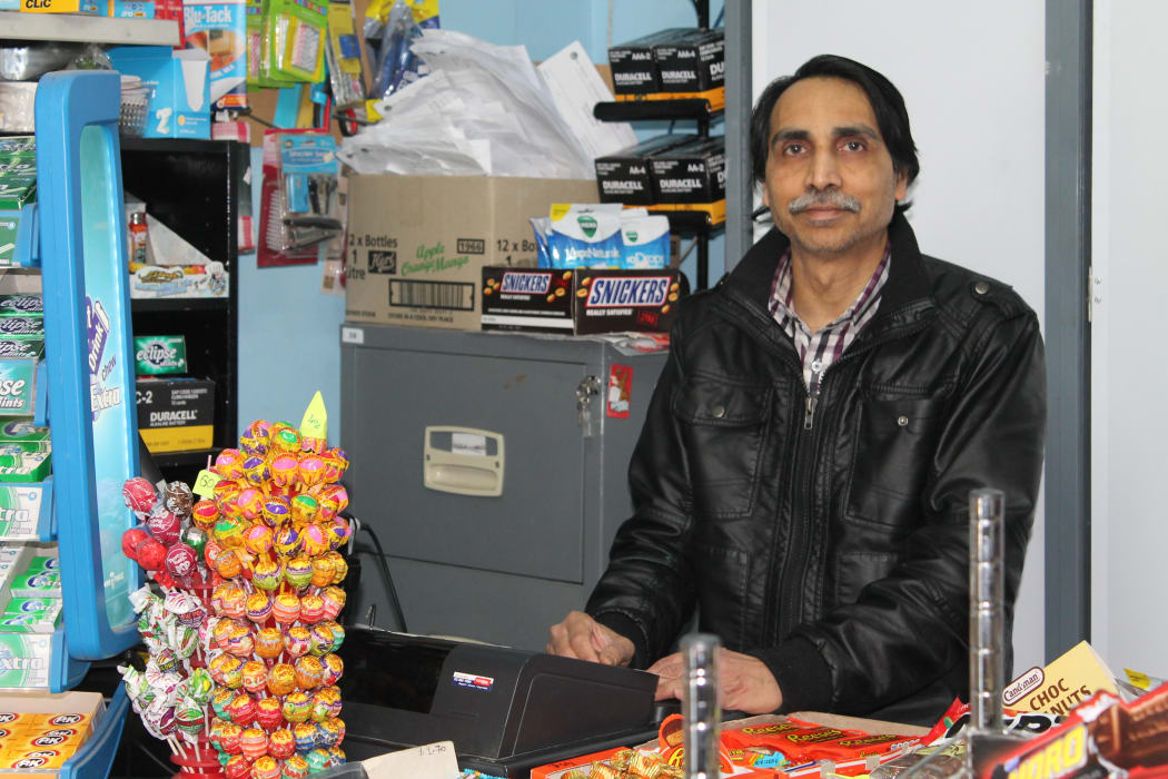 A photo of Kamlesh Patel at his counter. Earlier this year he fought with a robber who was trying to open his cigarette shutter.