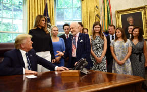 US President Donald Trump speaks with Apollo 11 crew member Buzz Aldrin at the White House during a ceremony commemorating the 50th anniversary of the Moon landing.