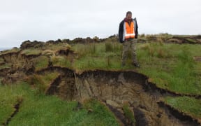 Adrian Benson inspects a land slump.
