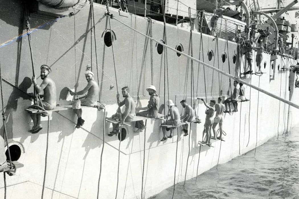 New Zealand naval ratings painting the cruiser Leander in Alexandria harbour, Egypt.