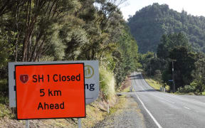 A sign warns of the highway closure