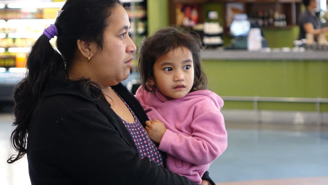 Ioane Teitiota's wife, Angua Erika, with one of the couple's three children at Auckland International Airport on Wednesday 23 September 2015. The family's application to be considered refugees from the effects of climate change in Kiribati has been declined, and Mr Teitiota is being deported today.