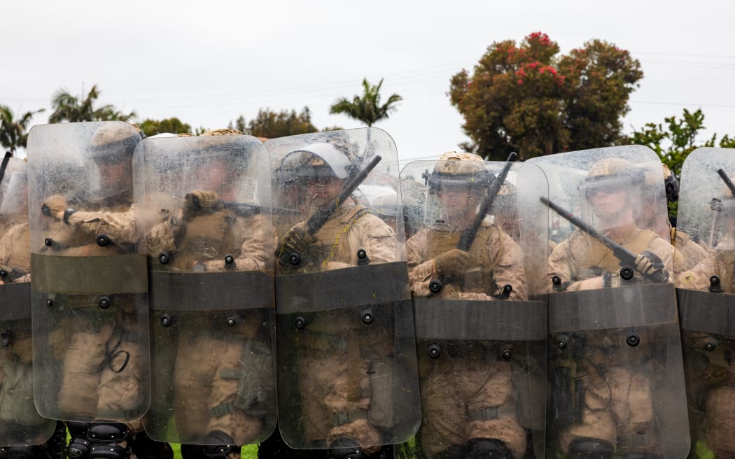 This handout photo taken and released by the US Marine Corps on June 10, 2025 shows US Marines with 2nd Battalion, 7th Marine Regiment, 1st Marine Division, who were placed in an alert status over the weekend to support US Northern Command’s mission, rehearsing nonlethal tactics in the greater Los Angeles area. President Donald Trump has deployed thousands of troops including 700 active duty US Marines to Los Angeles, despite California authorities saying the move is unnecessary and will inflame the situation. The 700 elite troops will join around 4,000 National Guard soldiers, a stunning militarization of the sprawling city, which is home to millions of foreign-born and Latino residents. (Photo by Juan TORRES / US MARINE CORPS / AFP) / RESTRICTED TO EDITORIAL USE - MANDATORY CREDIT "AFP PHOTO / US MARINE CORPS / CPL. JUAN TORRES  " - NO MARKETING - NO ADVERTISING CAMPAIGNS - DISTRIBUTED AS A SERVICE TO CLIENTS