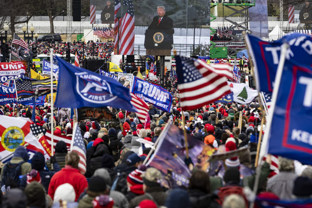 US President Donald Trump is seen on a screen as his supporters cheer during a rally on the National Mall on January 6, 2021 in Washington, DC.