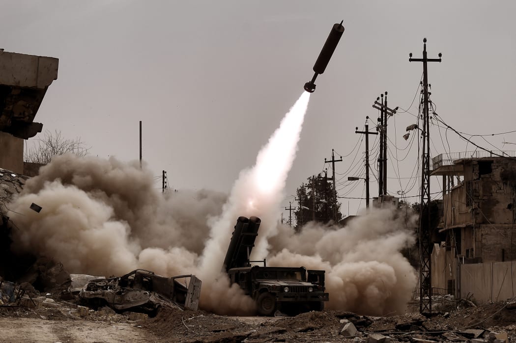 Iraqi troops fire artillery towards Islamic State (IS) jihadists' positions in west Mosul.