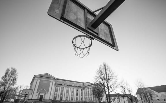 School building with basketball hoop.