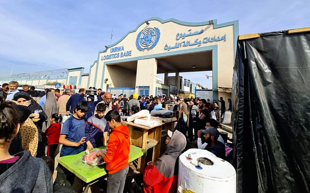 Palestinians gather at UNRWA Logistics Base in Rafah, the Gaza Strip,  the southern  Israeli-occupied territory on Dec. 17, 2023. More than tens of thousands of displaced Palestinians have crammed into Rafah to avoid Israeli strikes.