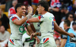 Taine Tuaupiki and Charnze Nicoll-Klokstad celebrate a try against the Dolphins.