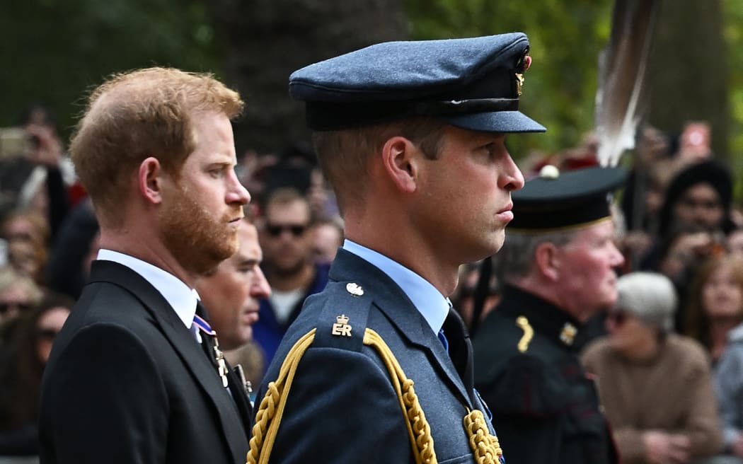 (FILES) In this file photo taken on September 19, 2022 Britain's Prince William, Prince of Wales (R) and Britain's Prince Harry, Duke of Sussex, follow the coffin of Queen Elizabeth II from Westminster Abbey to Wellington Arch in London after the State Funeral Service. (Photo by Paul ELLIS / POOL / AFP)