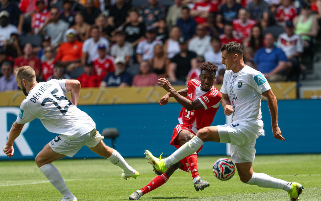 Bayern Munich's Kingsley Coman gets the better of Auckland City FC's Michael Den Heijer and Adam Mitchell.