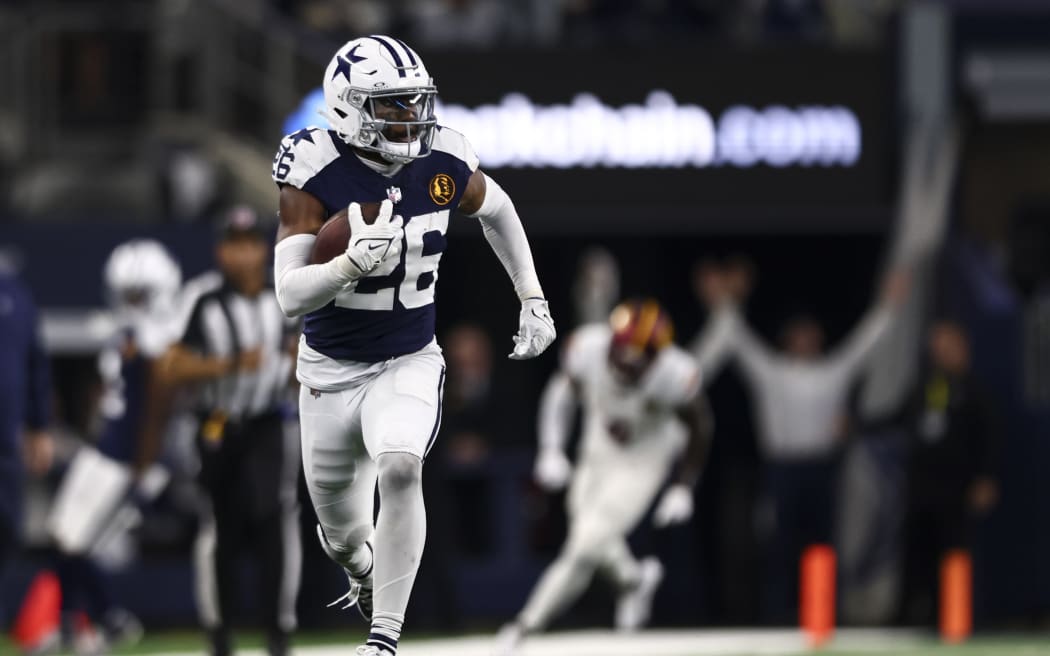 ARLINGTON, TX - NOVEMBER 23: DaRon Bland #26 of the Dallas Cowboys returns an interception for a touchdown during an NFL football game against the Washington Commanders at AT&T Stadium.