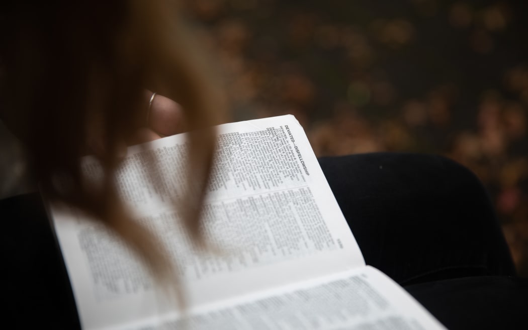 Cassie Dean leafs through the pages of her childihood bible, the New World Translation of the Holy Scriptures.