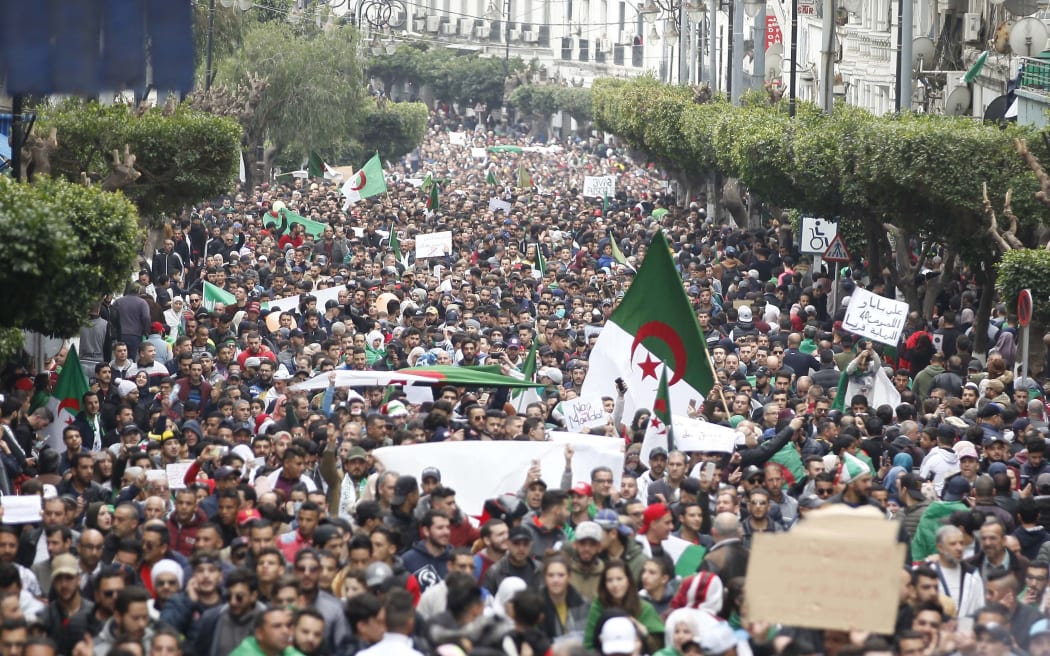 Algerian protesters chant slogans and sit down at a demonstration against Abdelaziz Bouteflika's fifth term in Algiers, Algeria