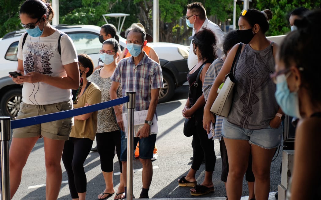 Residents wait to vote for the referendum on independence outside a polling station of the City Hall in Noumea, on the French South Pacific territory of New Caledonia on December 12, 2021.