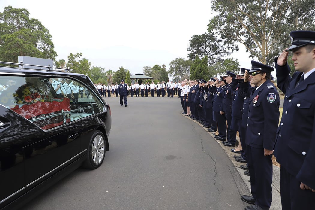 Firefighters form a guard of honour at the funeral of Geoffrey Keaton, in Sydney.