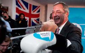 Brexit Party leader Nigel Farage poses for a photograph in boxing gloves during his visit to Gator ABC Boxing Club in Ilford, east London on November 13, 2019.