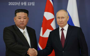 (FILES) This pool image distributed by Sputnik agency shows Russian President Vladimir Putin (R) and North Korea's leader Kim Jong Un (L) shaking hands during their meeting at the Vostochny Cosmodrome in Amur region on September 13, 2023, ahead of planned talks that could lead to a weapons deal with Russian President. Russian President Vladimir Putin will travel to North Korea on June 18, 2024, in a rare visit that may see Moscow sign a "strategic partnership treaty" with Pyongyang, the Kremlin said.