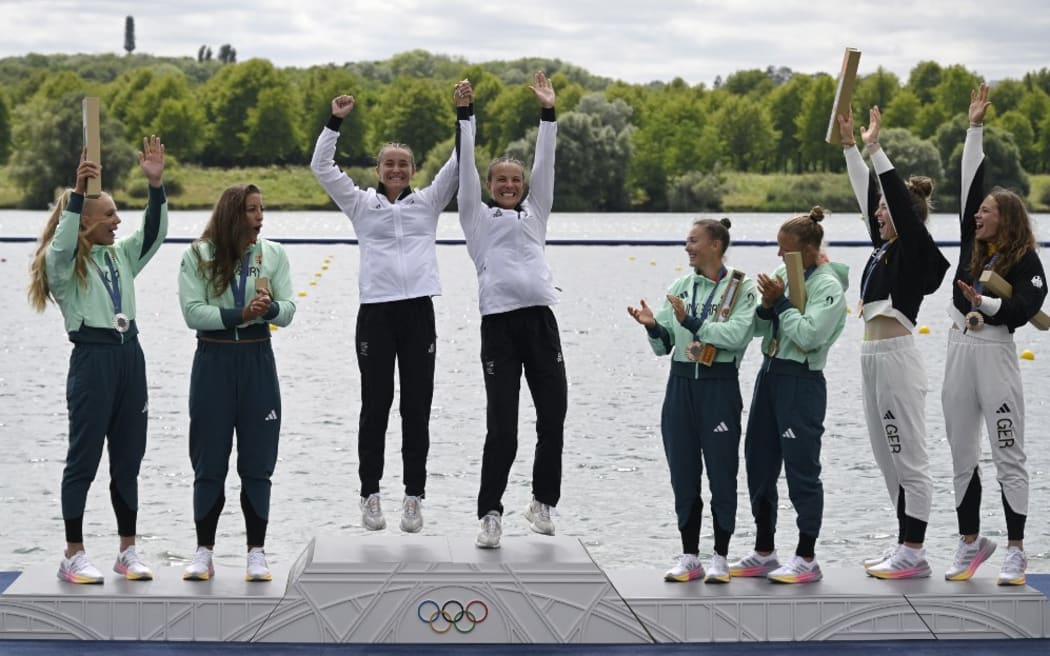 (From L) Hungary's silver medallists Tamara Csipes and Alida Dora Gazso, New Zealand's gold medallists Lisa Carrington and Alicia Hoskin, and bronze medallists Germany's Paulina Paszek and Jule Marie Hake, and Hungary's Noemi Pupp and Sara Fojt celebrate on the podium during the medal ceremony after the women's kayak double 500m final of the canoe sprint competition at Vaires-sur-Marne Nautical Stadium in Vaires-sur-Marne during the Paris 2024 Olympic Games on August 9, 2024. (Photo by Olivier MORIN / AFP)