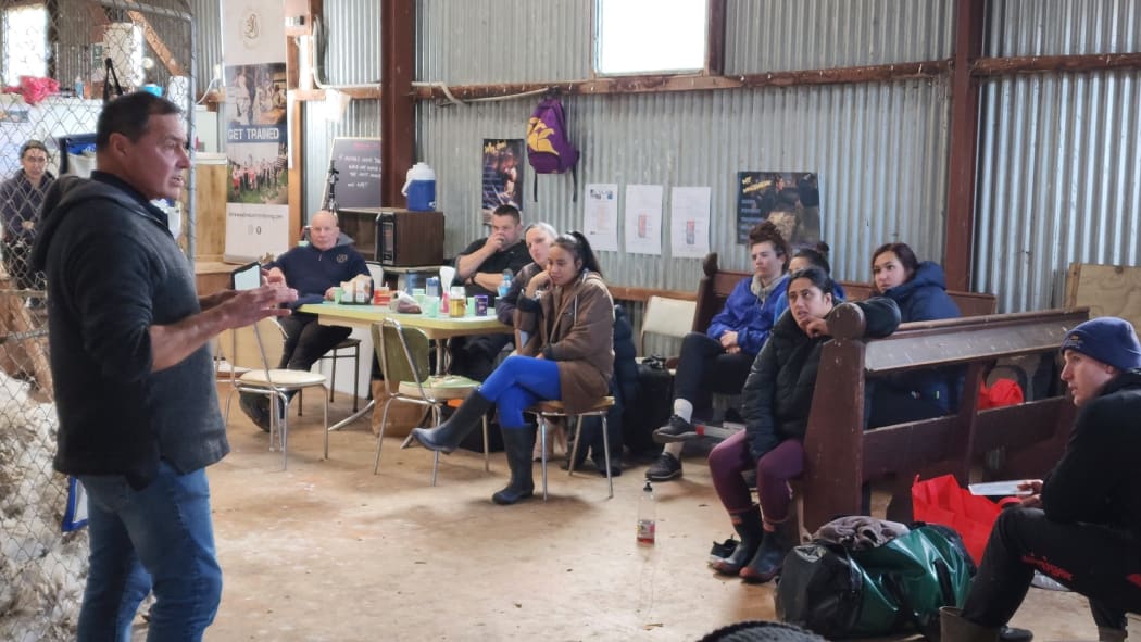 Shearing contractor Dion Morrell, left, a former champion shearer and world record holder, tutoring budding shearers and woolhandlers.