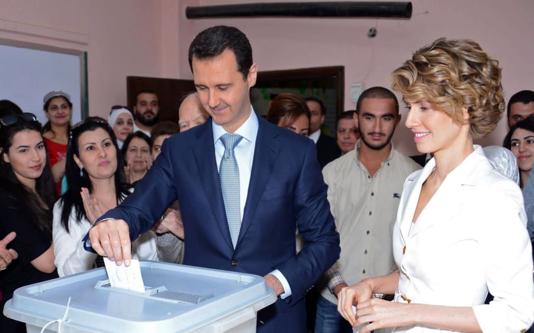 President Bashar al-Assad and wife Asma al-Assad casting their votes at a polling station in Maliki.