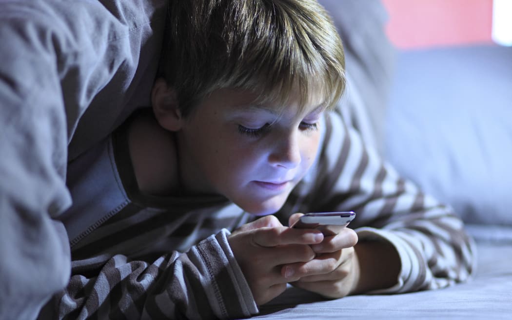 France, young boy in his bed. (Photo by Philippe Turpin / Photononstop via AFP)