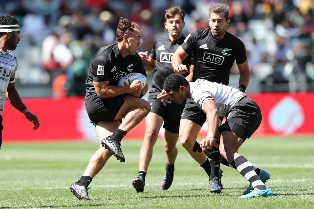 New Zealand's Joe Webber takes on the Fiji defence in the Cup Semi Final in Cape Town.