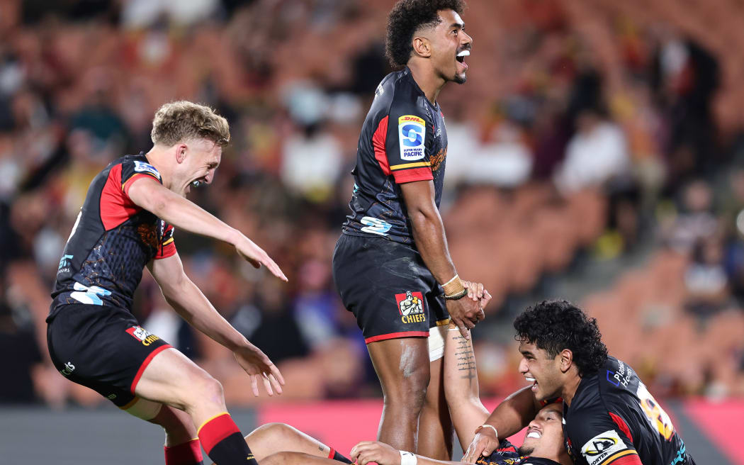 Damian McKenzie and Emoni Narawa celebrate Sione Ahio’s try.