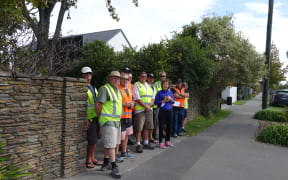 Members of the Rail and Maritime Transport Union and supporters distributing leaflets outside the home of one of the directors of the Lyttelton Port Company.