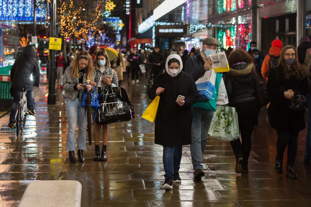 Shoppers walk along Oxford Street as new coronavirus restrictions, announced today by British Prime Minister Boris Johnson, are due to take effect from midnight on Sunday