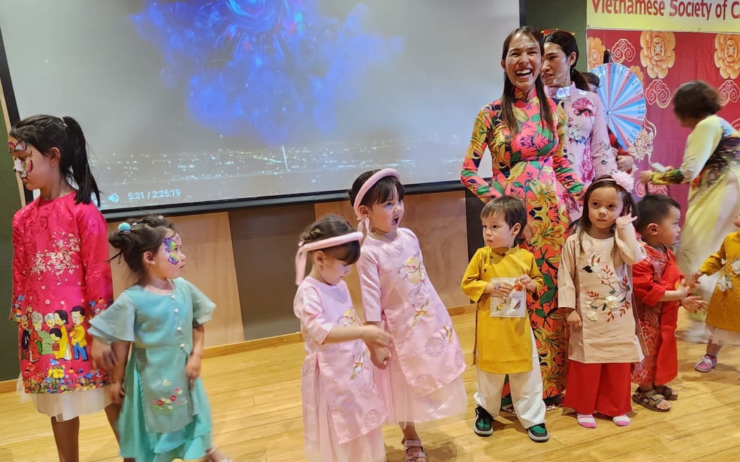 Families in traditional Vietnamese dress celebrating the Mid-Autumn Festival in 2024.