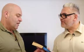 Comedian Leigh Hart shows Victor Rodger one of his favourite books in a video for the reading campaign Blokes vs Books