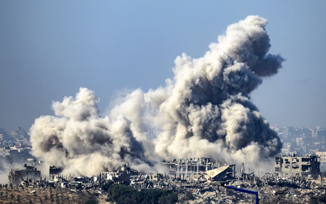 This picture taken from southern Israel near the border with the Gaza Strip shows smoke rising from buildings after being hit by Israeli strikes, as battles resume between Israel and Hamas militants, on December 1, 2023. A temporary truce between Israel and Hamas expired on December 1, with the Israeli army saying combat operations had resumed, accusing Hamas of violating the operational pause. (Photo by John MACDOUGALL / AFP)