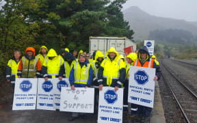Picketing workers near rail tunnel entrance