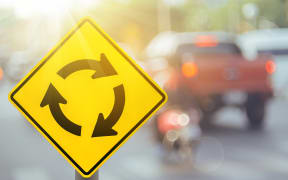 Stock photo of a roundabout sign.