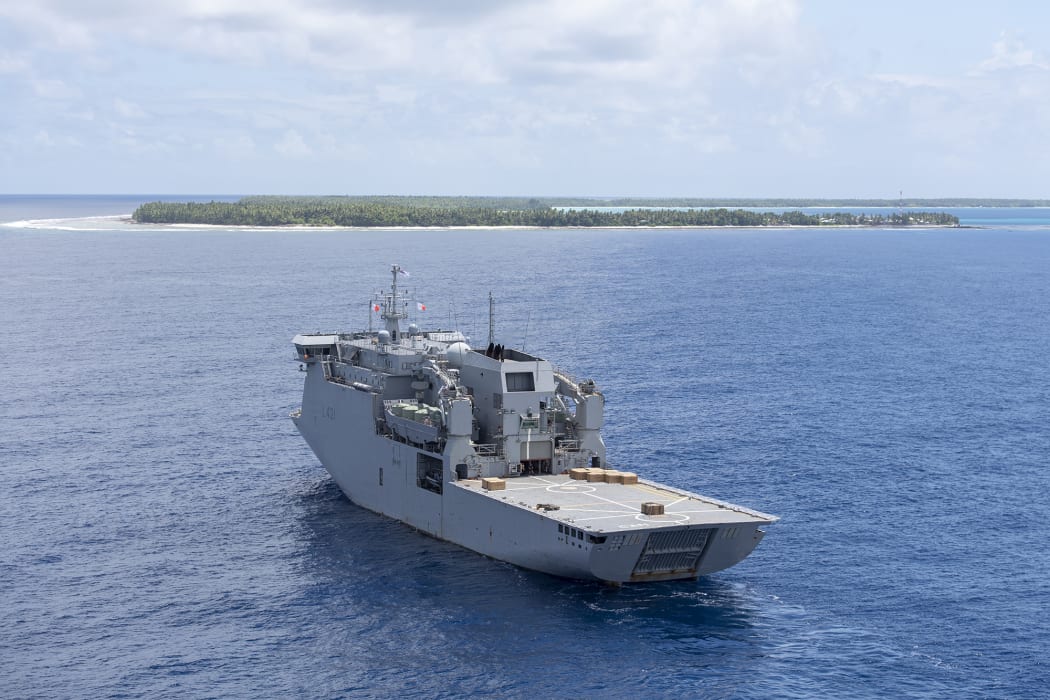 HMNZS Canterbury, pictured with Atafu atoll in the background.