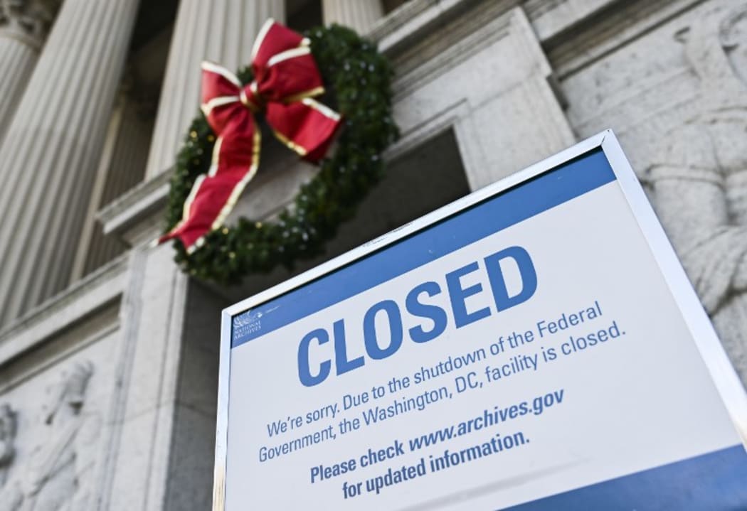 A sign is displayed at the National Archives building that is closed because of a US government shutdown in Washington, DC, on December 22, 2018. - AFP