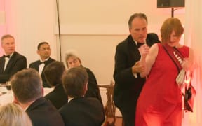 A still image taken from UK Pool video footage on June 21, 2019 shows Conservative MP Mark Field tackling a Greenpeace climate protester at a dinner at Mansion House in the City of London on June 21, 2019.
