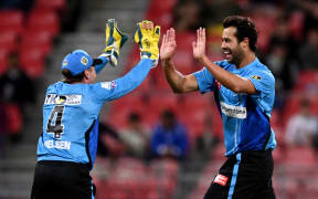 Wes Agar of the Strikers (right) celebrates with Harry Nielsen during the Big Bash League cricket match between the Sydney Thunder and the Adelaide Strikers in Sydney.