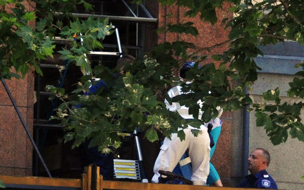 People are evacuated from a building in Sydney's CBD due to a siege under way in Martin Place