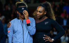 US Open winner Naomi Osaka is comforted by runner up Serena Williams during the trophy presentation