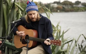 Lawrence Arabia (James Milne) performs next to Lake Pupuke.