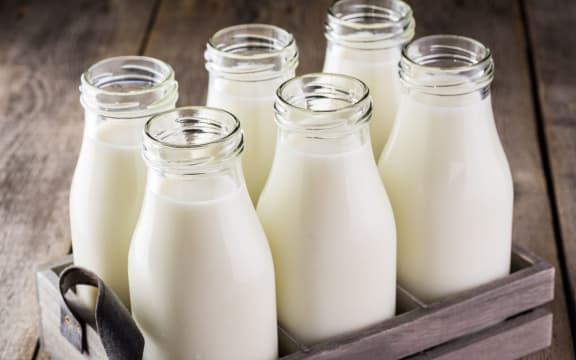 43843255 - close up of bottles of milk in a wood box.