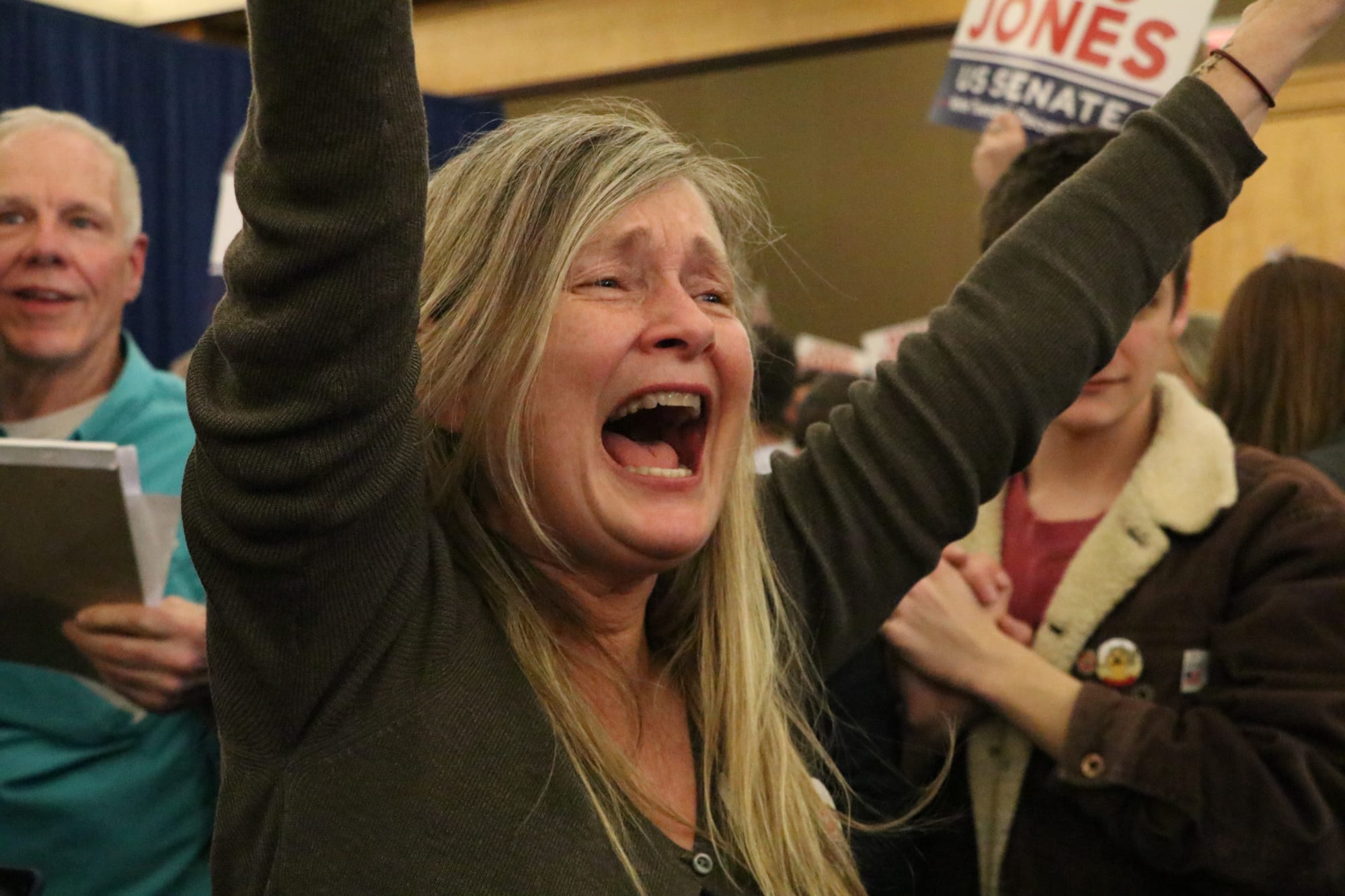 A supporter cheers for Democratic U.S. Senator elect Doug Jones during his election night gathering at the Sheraton Hotel.