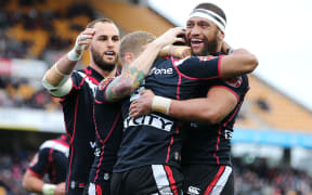 The Warriors celebrate Dominique Peyroux's try.