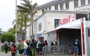 People line up outside Eden Park to collect food and Christmas gifts from Auckland City Mission.
