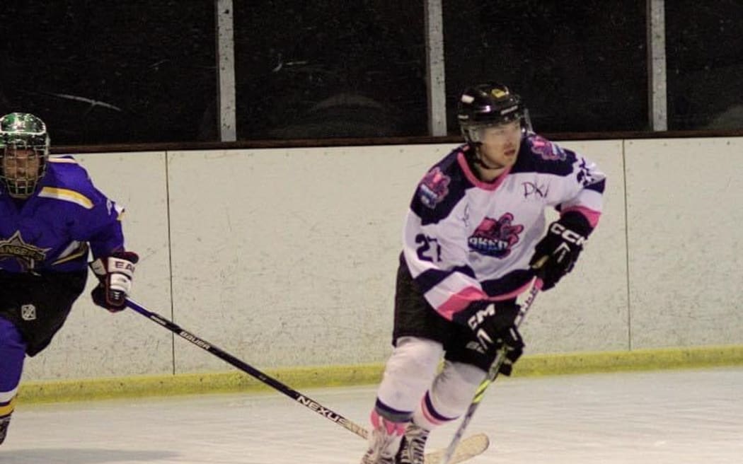 Two players in action playing ice hockey.
